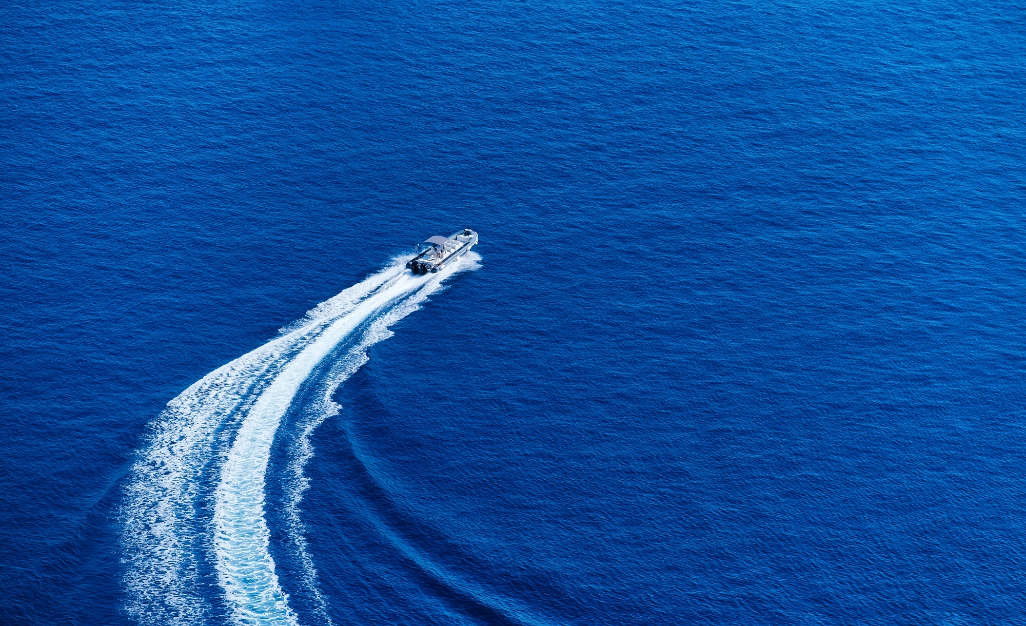 Greece. View of the speedboat and the blue sea water.